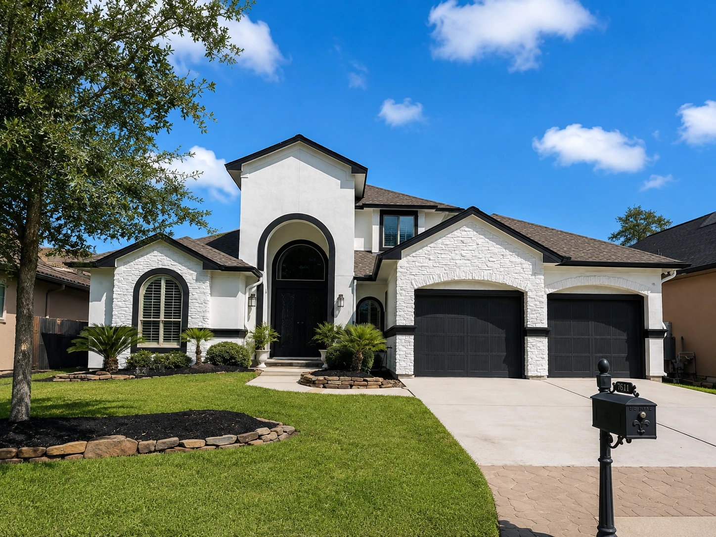 Same residential exterior completed in white with dark accents