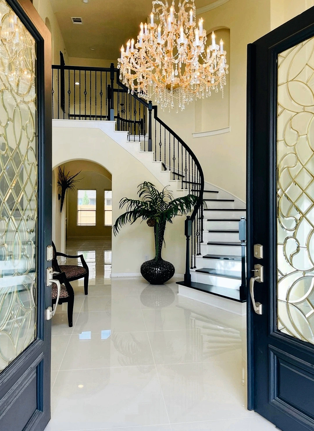 Grand entry with chandelier and staircase finish work