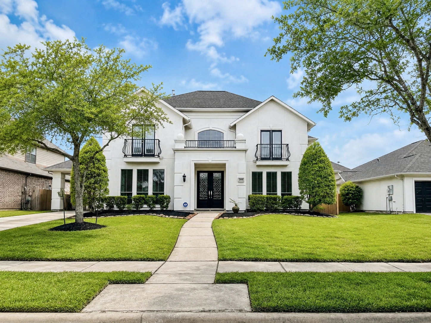 Two-story residential exterior after white paint transformation