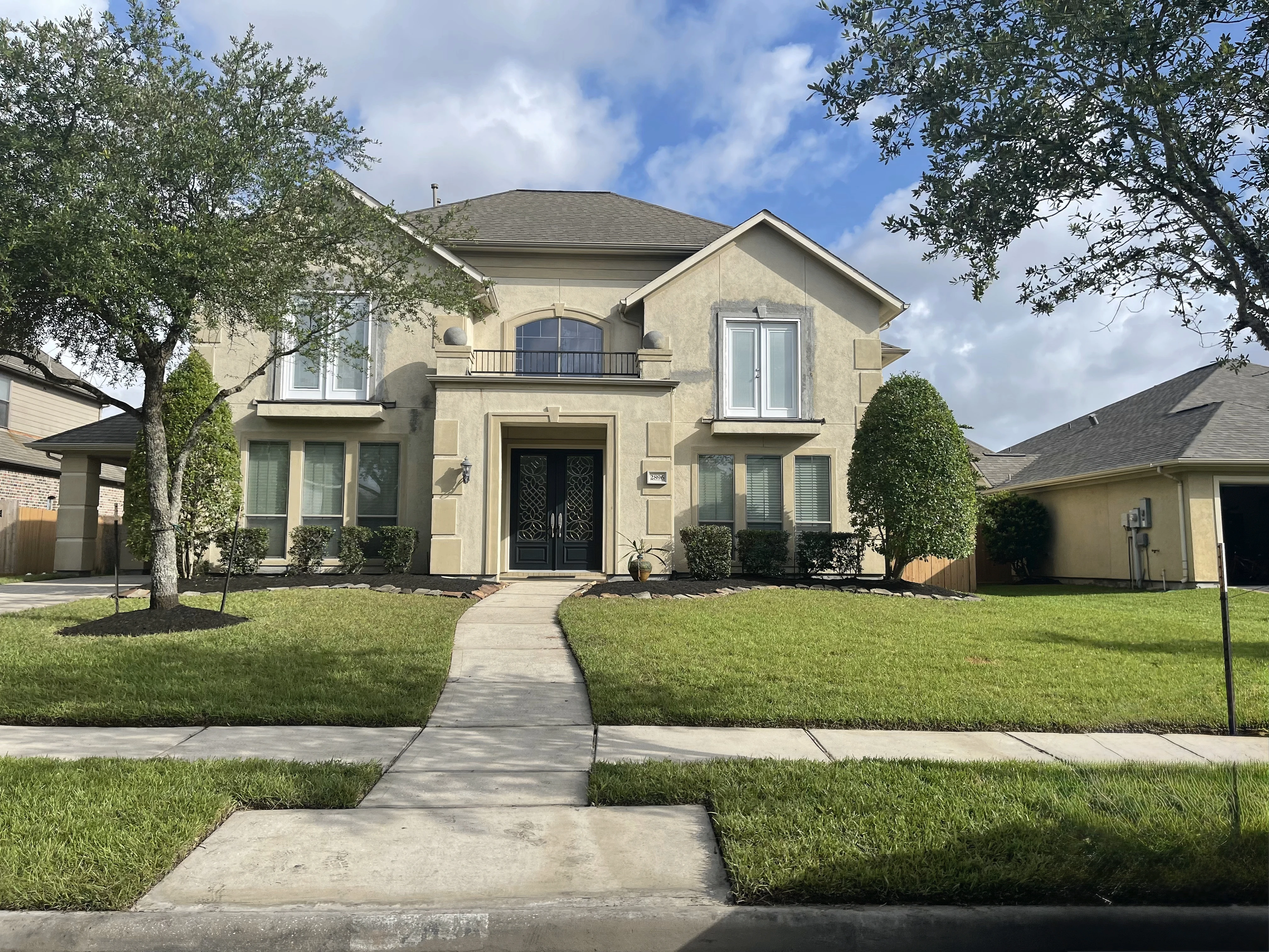 Two-story residential exterior before painting